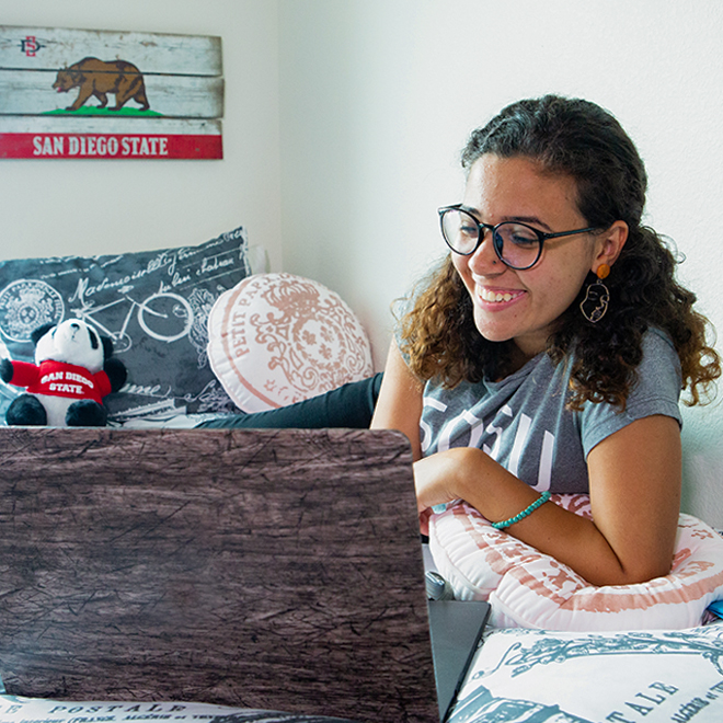 student on laptop in room.